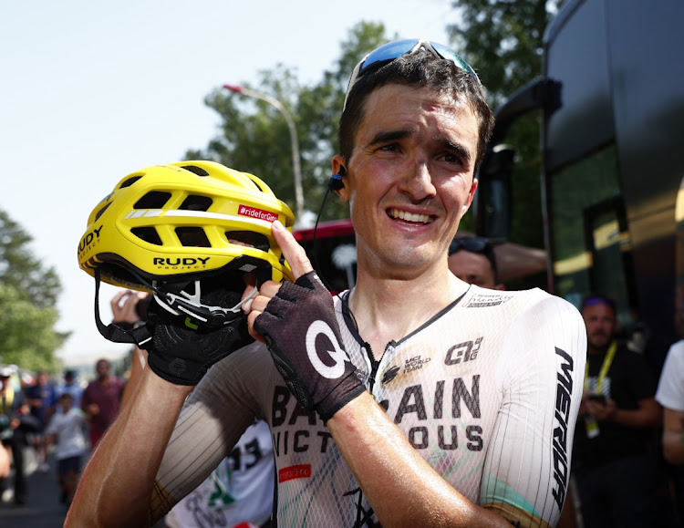 Team Bahrain Victorious' Pello Bilbao Lopez celebrates after winning stage 10 of the Tour de France from Vulcania to Issoire, France, and points at the sticker on his helmet in memory of the late cyclist Gino Maer on July 11 2023.