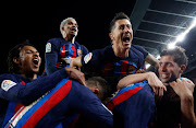 FC Barcelona's Franck Kessie celebrates scoring their second goal with Robert Lewandowski and other teammates in the LaLiga match against Real Madrid at Camp Nou in Barcelona on March 19 2023.