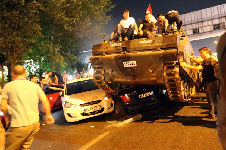 Civilians ride on army tanks in Istanbul after last July's military coup in Turkey failed. File photo.