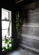 For the bathroom Kim opted for a natural cement palette and installed an oversized open-plan shower.