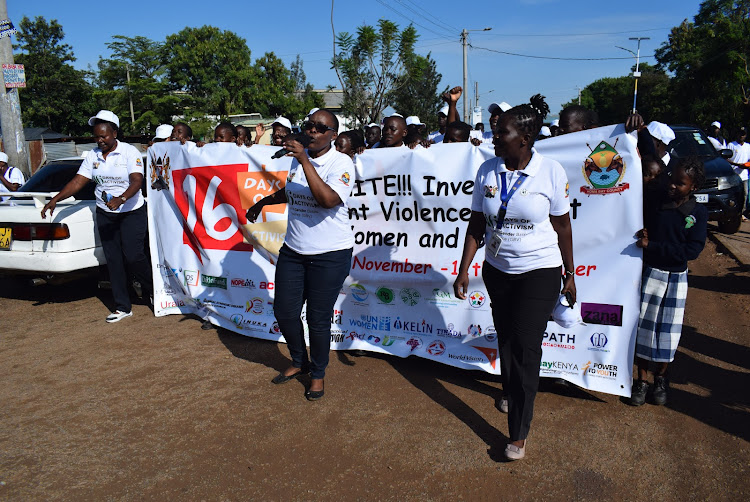 Janet Akech of Breakthrough Action with Caroline Owidhi lead other gender rights activtists in a procession to stop gender based violence as they marked the 16 days of GBV in Homa Bay town on November 27,2023