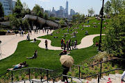 People visit Little Island Park, almost three acres of new public park space which sits on stilts over the Hudson River and the remnants of Pier 54 in the larger Hudson River Park, on Manhattan's West Side, during the park's opening day in New York City, New York, US, May 21, 2021. 