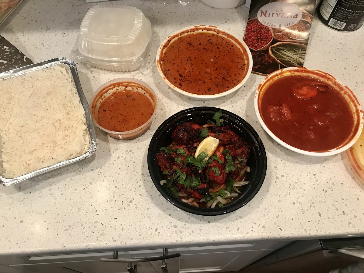 Tandoori chicken in front, shrimp vindaloo on the right. Chick tikka masala in the back