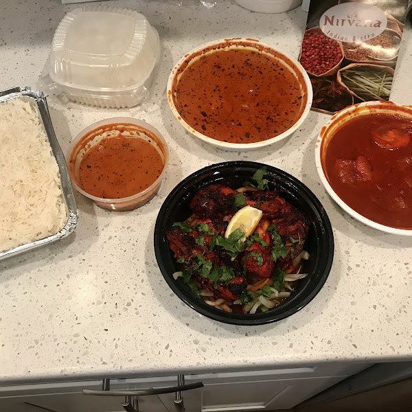 Tandoori chicken in front, shrimp vindaloo on the right. Chick tikka masala in the back