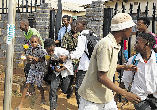 PILLAGE: Young looters leave a shop in Meadowlands, Soweto