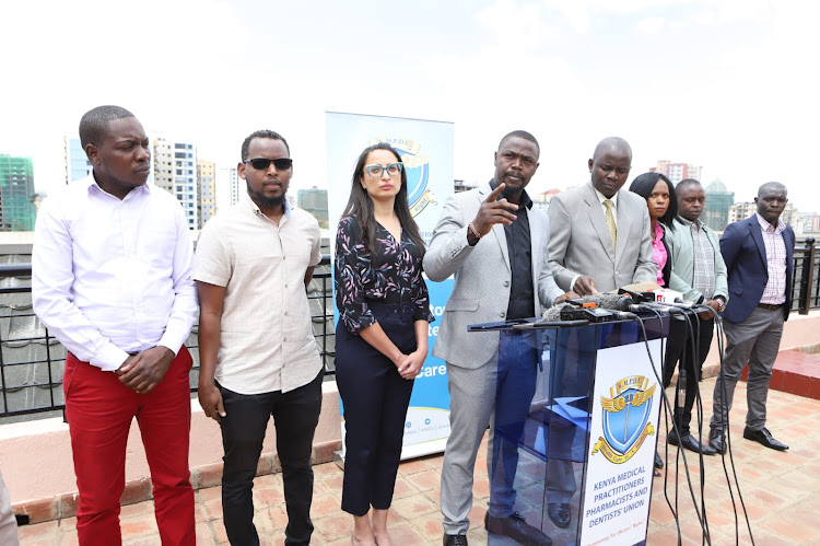 Kenya Medical Practitioners Pharmacist and Dentists Union (KMPDU) secretary general Davji Bhimji flanked by other officials during a press briefing on suspension of industrial action at KMPDU offices in Kilimani, Nairobi on January 5, 2022.