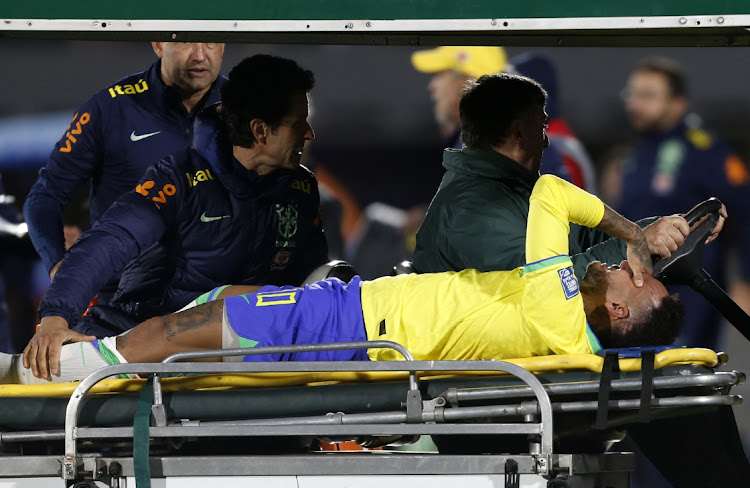 Brazil's Neymar is brought off the pitch after sustaining an injury.