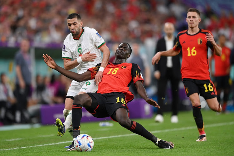 Hakim Ziyech tries to get past Belgium's Amadou Onana in Morocco's World Cup Group F win at Al Thumama Stadium on November 27 2022.