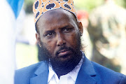 Former al Shabaab group co-founder and spokesperson Mukhtar Robow sits among colleagues after he was named  as the minister in charge of religion by Prime Minister Hamza Abdi Barre in  Mogadishu, Somalia August 2, 2022. 