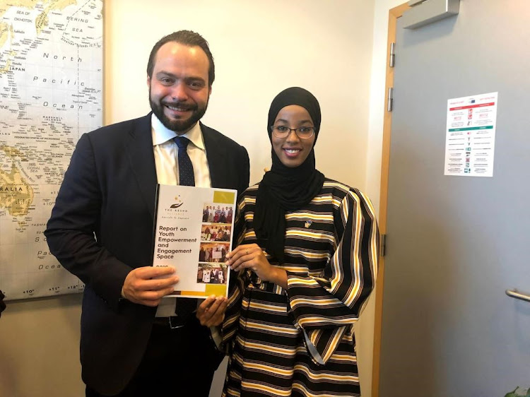Umulkher Harun presents the work of Kesho Alliance to Fabio Massimo Castaldo, a member of the European Parliament, at a meeting in Brussels in 2019.