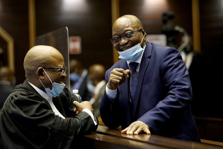 Former president Jacob Zuma speaks with his legal representative at the High Court in Pietermaritzburg on May 17, 2021, for the first day of his corruption, fraud, money laundering, racketeering and tax evasion trial. Photo: SANDILE NDLOVU