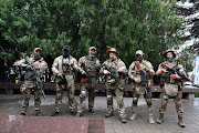 Fighters of Wagner private mercenary group pose for a picture as they get deployed near the headquarters of the Southern Military District in the city of Rostov-on-Don, Russia, June 24, 2023.