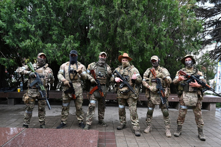 Fighters of Wagner private mercenary group pose for a picture as they get deployed near the headquarters of the Southern Military District in the city of Rostov-on-Don, Russia, June 24, 2023.