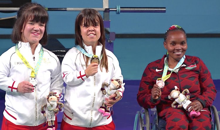 paralifting Bronze medallist Helen Wawira alongside Great Britain's Zoe Newson and Olivia Broome,