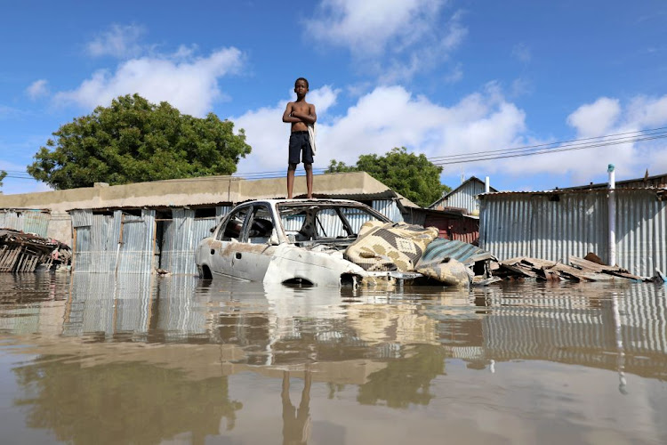 A Somali boy stands on a junk vehicle after heavy rain flooded their neighbourhood in Mogadishu, Somalia, on October 21 2019.