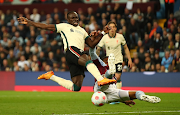 Sadio Mane of Liverpool is challenged by Ezri Konsa of Aston Villa in the Premier League match at Villa Park in Birmingham on May 10 2022.