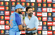 India captain Rohit Sharma receives the series trophy after game three of the T20 International series against Australia at Rajiv Gandhi International Stadium in Hyderabad, India on September 25 2022.