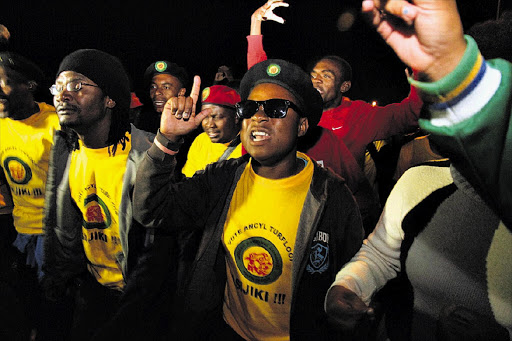 Supporters of expelled ANC Youth League president Julius Malema, some making the 'showerhead' gesture directed at President Jacob Zuma, at a night vigil for Malema in Polokwane last night.