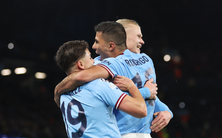 Erling Haaland celebrates with teammates Rodri and Julian Alvarez after scoring Manchester City's third goal in the Uefa Champions League quarterfinal first leg match against Bayern Munich at Etihad Stadium in Manchester on April 11 2023.