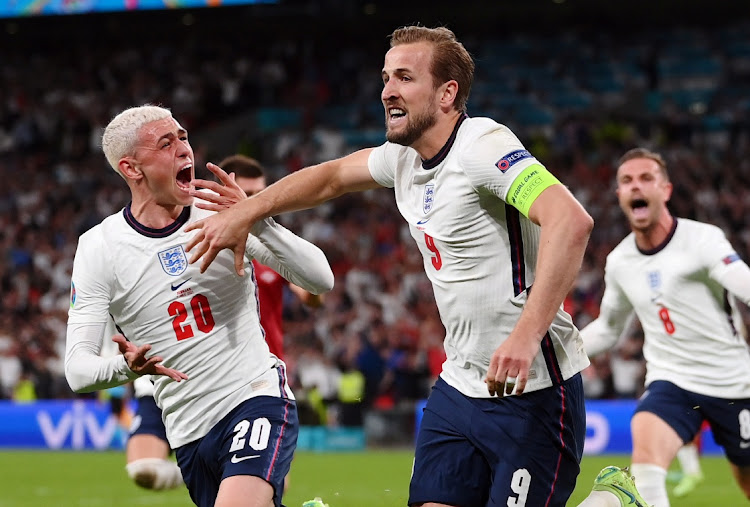 England's Harry Kane celebrates scoring a penalty with teammate Phil Foden in the Euro 2020 semifinal against Denmark at Wembley Stadium, London on July 7, 2021