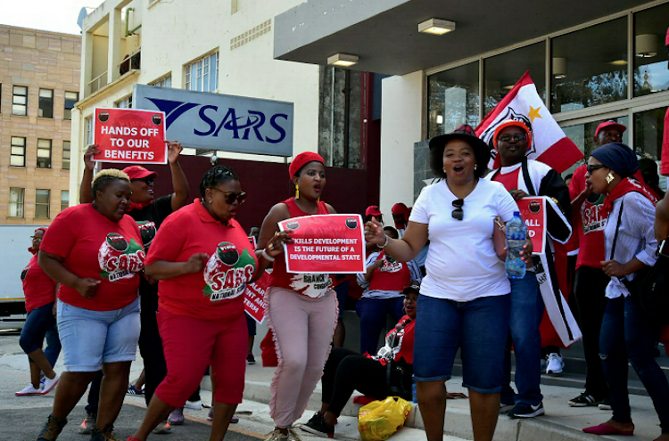 Sars employees picket outside the Sars offices in Central, Port Elizabeth, on Thursday as part of a national strike. Workers affiliated to the National Education, Health and Allied Workers’ Union and the Public Servants Association are demanding an 11.4% salary increase