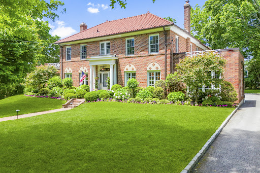 Brick house with green lawn in this luxury property for sale in Larchmont ($4,795,000)