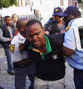 Kgotsi Chikane being arrest in Parliament. Picture Credit: Gentle Magic (@ShazLNS)