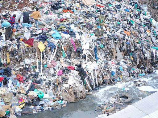 Children playing along Nairobi river where garbage has been dumped in Kiambio Village Sunday evening. photo/PATRICK VIDIJA