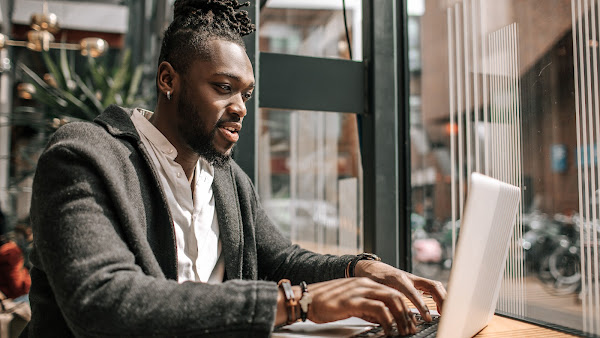 Man in a suit working on a laptop