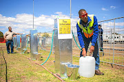 Brandon Herringer, a City of Cape Town plumber, uses a water point Cape Town residents will use when 'day zero' arrives.