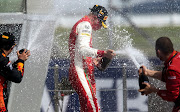 Mick Schumacher celebrates winning the formula 2 race on the podium during the Russian Grand Prix at th Sochi Autodrom, in Sochi on September 26, 2020.