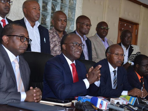 Seated from left Housing and Urban Development PS Charles Mwaura , Transport CS James Macharia and Public Works PS Paul Maringa with the representatives of the public transport sector at Transcom House, Nairobi /COURTESY