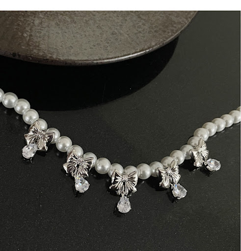 Title 6, Bow Pearl Zircon Necklace A stunning necklace w...