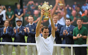  Switzerland’s Roger Federer celebrates with the trophy after winning the final against Croatia’s Marin Cilic.    