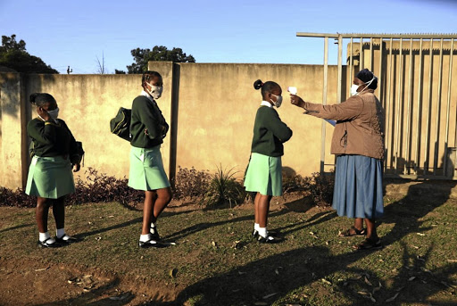 Pupils are screened before entering class. File photo.