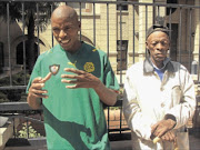 SEEKING JUSTICE: The deceased's brother, Thekiso, and their father Daniel Botsane outside the Bloemfontein High Court yesterday.   PHOTO: MICHAEL TLHAKUDI