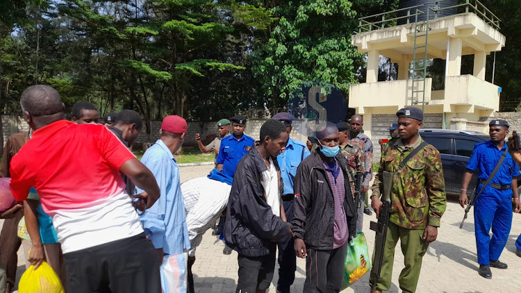 Followers of controversial Pastor Paul Mackenzie being supported by police after staging a hunger strike while in police custody for 10 days on June 14, 2023