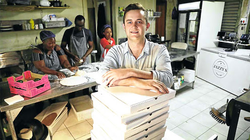 Jasper Meyer, founder and CEO of SmartKitchenCo, with employees in the background.