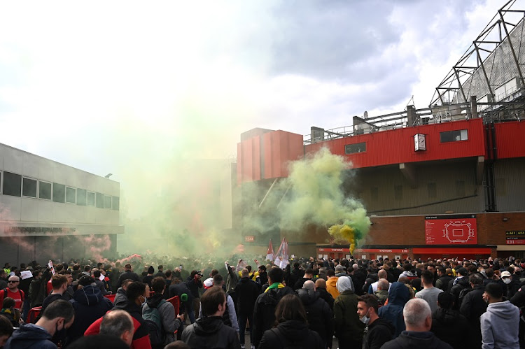 Fans are seen protesting Manchester United's Glazer ownership outside the stadium prior to the Premier League match between Manchester United and Liverpool at Old Trafford on May 02, 2021 in Manchester, England.