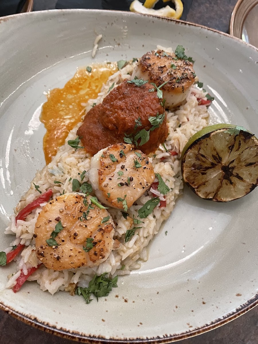 SCALLOP DIABLO Pan-Seared jumbo scallops served over piquillo rice & crab, topped with diablo sauce; finished with a charred lime & cilantro