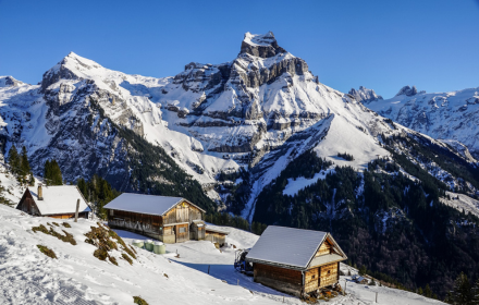 Wooden house in the snowy mountains small promo image