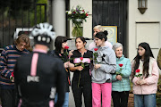 The devastated Otto family welcomes riders outside their home.