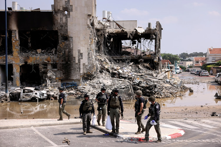 Israeli security at the site of a battle in Sderot, southern Israel, after a mass infiltration by Hamas gunmen from the Gaza Strip on October 8 2023.