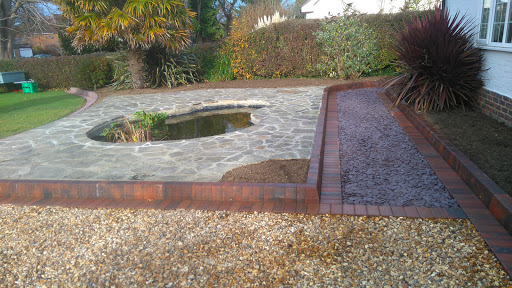 Gravel driveway, york paving around pond and slate path with brindle edging