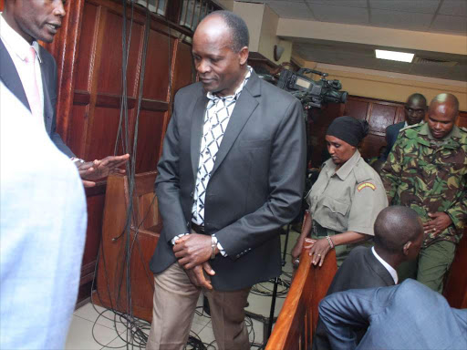 Migori governor Okoth Obado (in chains) leaves a Milimani court on Monday,October 8 when he came for the hearing of his bond application in a case in which he is charged with the murder of Sharon Otieno. /COLLINS KWEYU