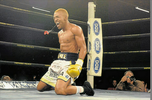 DONE AND DUSTED: Azinga Fuzile celebrates after knocking out Tshifhiwa Munyai during the semifinal of the Featherweight Super Four Series at Emperors Palace in Johannesburg on Saturday evening. Picture: GALLO IMAGES