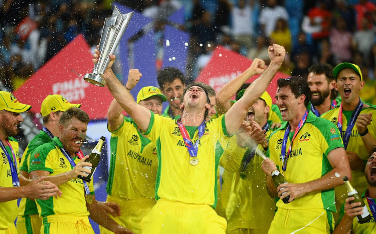 Mitchell Marsh of Australia with the ICC Men's T20 World Cup Trophy and teammates after they beat New Zealand in the final at Dubai International Stadium on November 14 2021. Picture: GETTY IMAGES/ALEX DAVIDSON