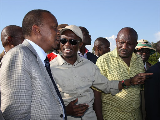 President Uhuru Kenyatta with Budalang'i MP Ababu Namwamba during a past visit to the constituency. /FILE