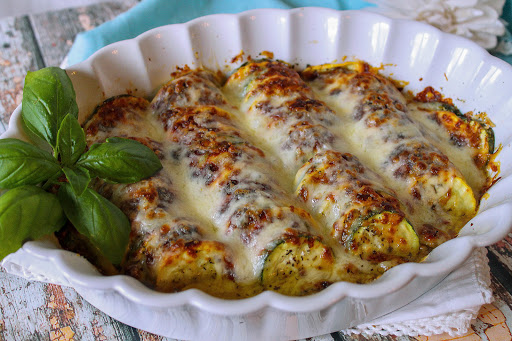 Summer squash cheesy bake in a dish with melted cheese.