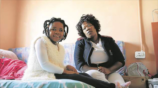 MOTHER’S LOVE: Sibuyiselwe Jiba with her daughter Siyahluma, 9, who was taken to St Elizabeth hospital in Lusikisiki for seizures. Today Siyahluma is severely disabled and blind and requires constant care Pictures: MARK ANDREWS